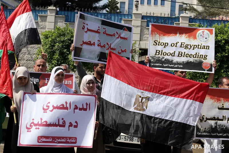 Palestinians protester carry a placard and gestures during a rally in support of ousted Egyptian president Mohamed Morsi, in Gaza City on August 19, 2013. Egypt closed its Rafah border crossing in Sinai with the Palestin...