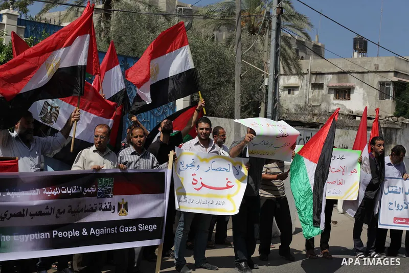 Palestinians protester carry a placard and gestures during a rally in support of ousted Egyptian president Mohamed Morsi, in Gaza City on August 19, 2013. Egypt closed its Rafah border crossing in Sinai with the Palestin...