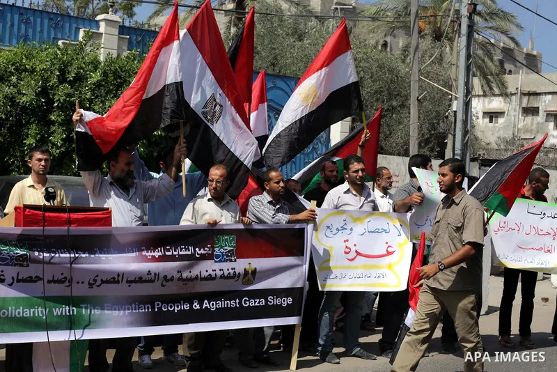 Palestinians protester carry a placard and gestures during a rally in support of ousted Egyptian president Mohamed Morsi, in Gaza City on August 19, 2013. Egypt closed its Rafah border crossing in Sinai with the Palestin...