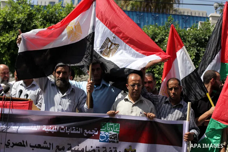 Palestinians protester carry a placard and gestures during a rally in support of ousted Egyptian president Mohamed Morsi, in Gaza City on August 19, 2013. Egypt closed its Rafah border crossing in Sinai with the Palestin...