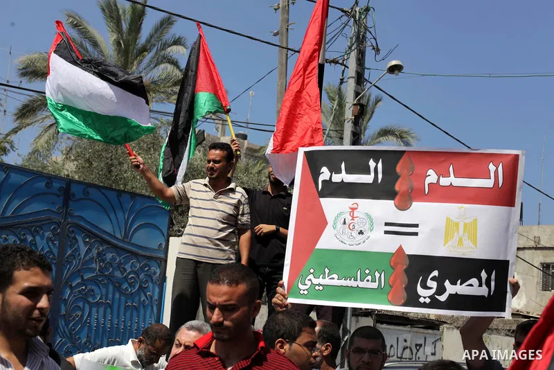 Palestinians protester carry a placard and gestures during a rally in support of ousted Egyptian president Mohamed Morsi, in Gaza City on August 19, 2013. Egypt closed its Rafah border crossing in Sinai with the Palestin...