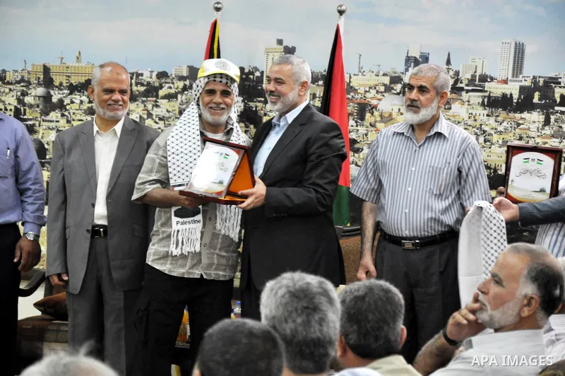 Palestinian Prime Minister in Gaza strip, Ismail Haniyeh, honors the prisoners released, in Gaza city on Aug. 19, 2013. Israel released 26 long-held Palestinian prisoners in a planned goodwill gesture hours ahead of a sc...