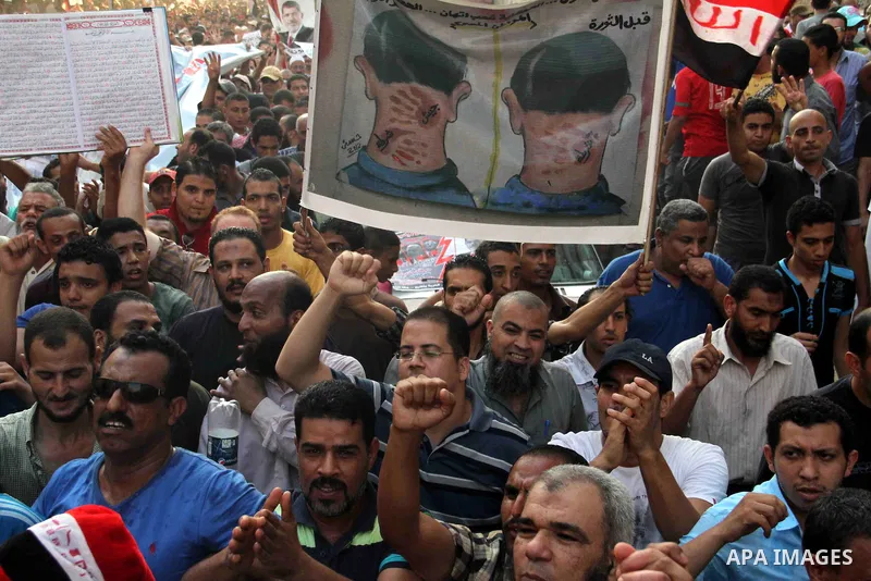 Supporters of Egypt's ousted President Mohammed Morsi, shout slogans during a protest in the Helwan district southern Cairo, Egypt, Monday, Aug. 19, 2013. Tensions in Egypt have soared since the army ousted Morsi, Hosni...