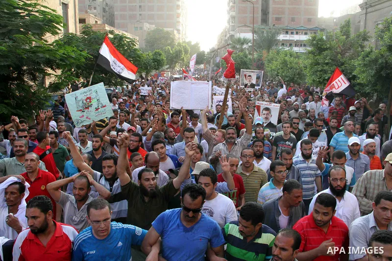 Supporters of Egypt's ousted President Mohammed Morsi, shout slogans during a protest in the Helwan district southern Cairo, Egypt, Monday, Aug. 19, 2013. Tensions in Egypt have soared since the army ousted Morsi, Hosni...