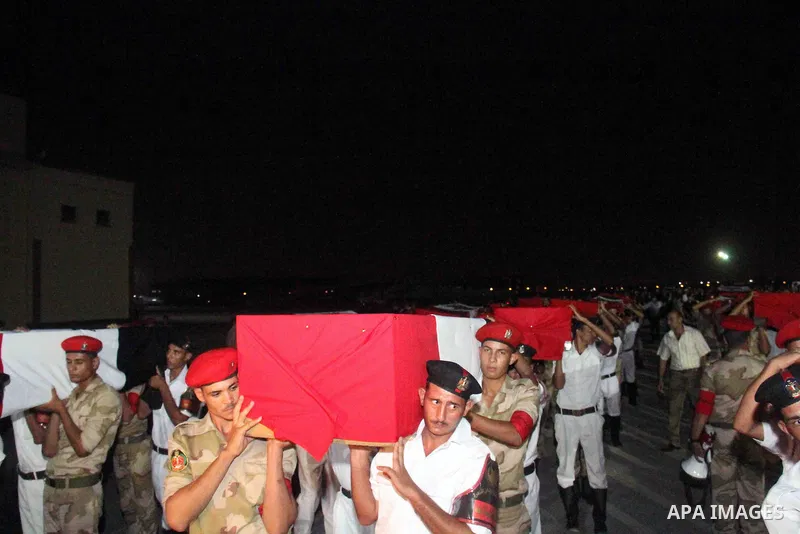 Egyptians gather around the coffins with the Egyptian Sinai policemen who were killed in Arish, during their funeral at Almaza military airport, Egypt, 19 August 2013. Egyptian security forces sealed off the Sinai Penins...