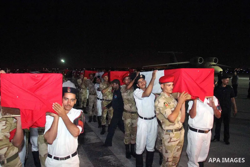 Egyptians gather around the coffins with the Egyptian Sinai policemen who were killed in Arish, during their funeral at Almaza military airport, Egypt, 19 August 2013. Egyptian security forces sealed off the Sinai Penins...