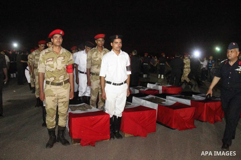 Egyptians gather around the coffins with the Egyptian Sinai policemen who were killed in Arish, during their funeral at Almaza military airport, Egypt, 19 August 2013. Egyptian security forces sealed off the Sinai Penins...