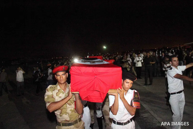 Egyptians gather around the coffins with the Egyptian Sinai policemen who were killed in Arish, during their funeral at Almaza military airport, Egypt, 19 August 2013. Egyptian security forces sealed off the Sinai Penins...