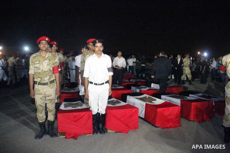 Egyptians gather around the coffins with the Egyptian Sinai policemen who were killed in Arish, during their funeral at Almaza military airport, Egypt, 19 August 2013. Egyptian security forces sealed off the Sinai Penins...