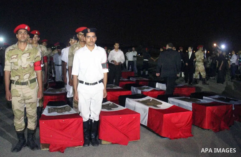 Egyptians gather around the coffins with the Egyptian Sinai policemen who were killed in Arish, during their funeral at Almaza military airport, Egypt, 19 August 2013. Egyptian security forces sealed off the Sinai Penins...