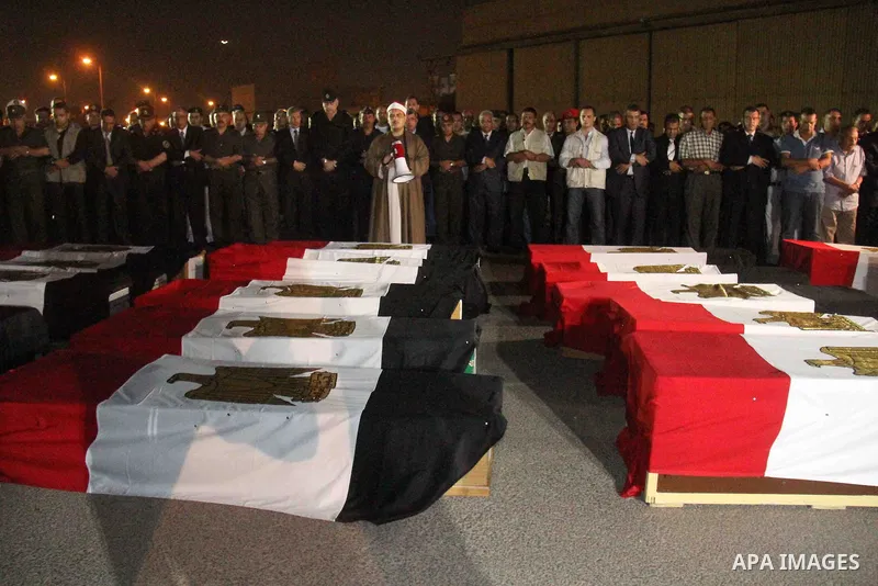 Egyptians gather around the coffins with the Egyptian Sinai policemen who were killed in Arish, during their funeral at Almaza military airport, Egypt, 19 August 2013. Egyptian security forces sealed off the Sinai Penins...