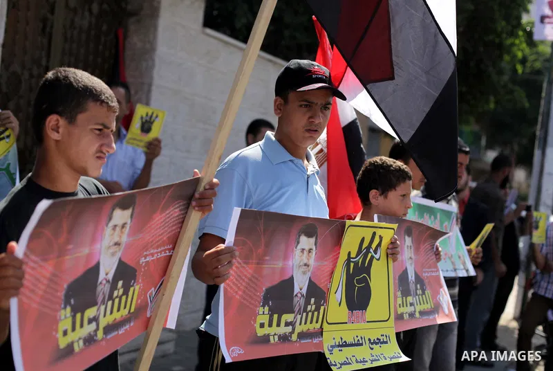 Palestinians protester carry a placard and gestures during a rally in support of ousted Egyptian president Mohamed Morsi, in Gaza City on August 20, 2013. Egypt closed its Rafah border crossing in Sinai with the Palestin...