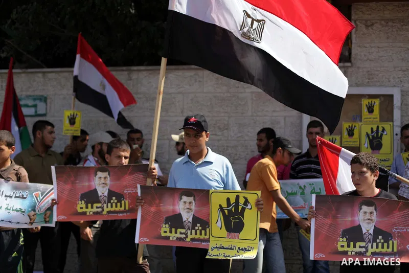 Palestinians protester carry a placard and gestures during a rally in support of ousted Egyptian president Mohamed Morsi, in Gaza City on August 20, 2013. Egypt closed its Rafah border crossing in Sinai with the Palestin...