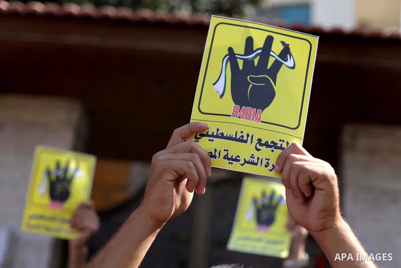 Palestinians protester carry a placard and gestures during a rally in support of ousted Egyptian president Mohamed Morsi, in Gaza City on August 20, 2013. Egypt closed its Rafah border crossing in Sinai with the Palestin...