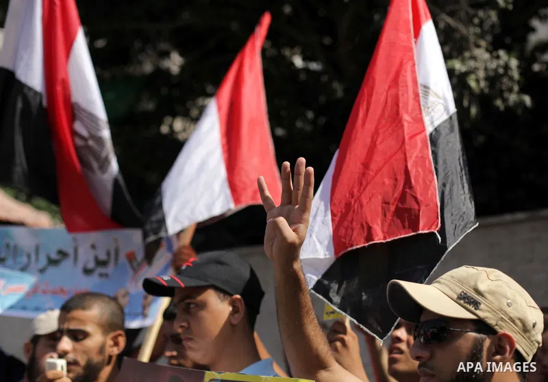 Palestinians protester carry a placard and gestures during a rally in support of ousted Egyptian president Mohamed Morsi, in Gaza City on August 20, 2013. Egypt closed its Rafah border crossing in Sinai with the Palestin...