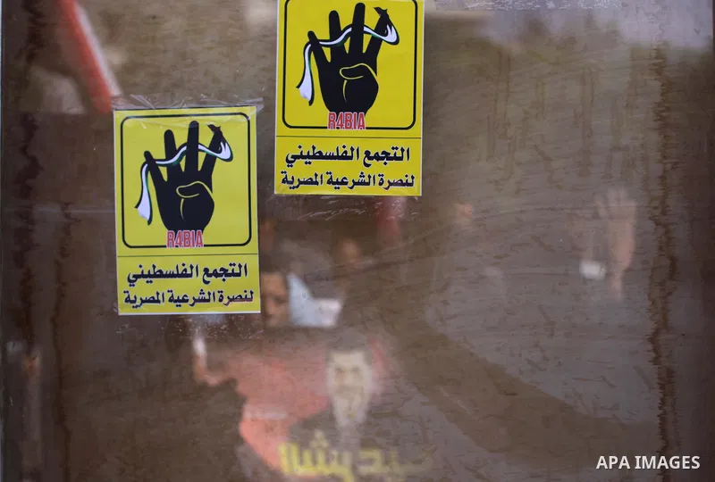 Palestinians protester carry a placard and gestures during a rally in support of ousted Egyptian president Mohamed Morsi, in Gaza City on August 20, 2013. Egypt closed its Rafah border crossing in Sinai with the Palestin...