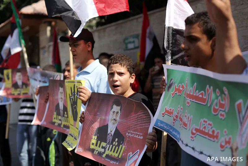 Palestinians protester carry a placard and gestures during a rally in support of ousted Egyptian president Mohamed Morsi, in Gaza City on August 20, 2013. Egypt closed its Rafah border crossing in Sinai with the Palestin...