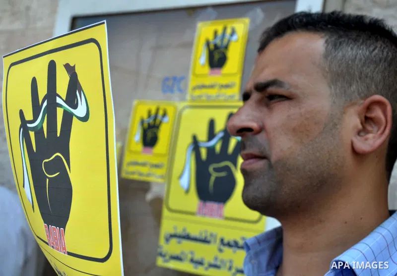 Palestinians protester carry a placard and gestures during a rally in support of ousted Egyptian president Mohamed Morsi, in Gaza City on August 20, 2013. Egypt closed its Rafah border crossing in Sinai with the Palestin...