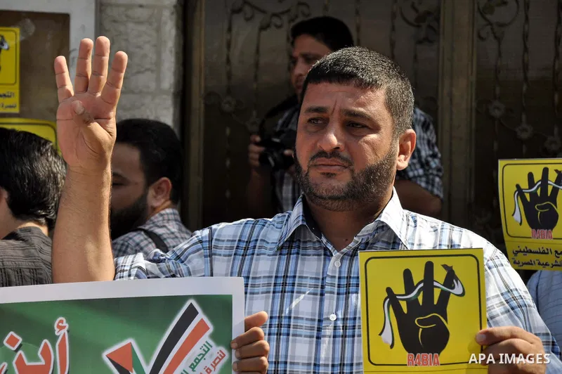 Palestinians protester carry a placard and gestures during a rally in support of ousted Egyptian president Mohamed Morsi, in Gaza City on August 20, 2013. Egypt closed its Rafah border crossing in Sinai with the Palestin...