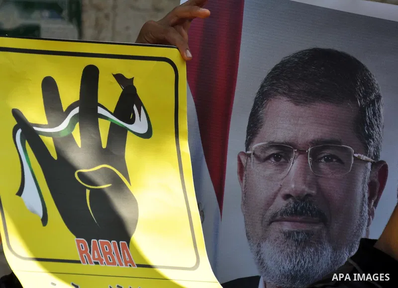 Palestinians protester carry a placard and gestures during a rally in support of ousted Egyptian president Mohamed Morsi, in Gaza City on August 20, 2013. Egypt closed its Rafah border crossing in Sinai with the Palestin...