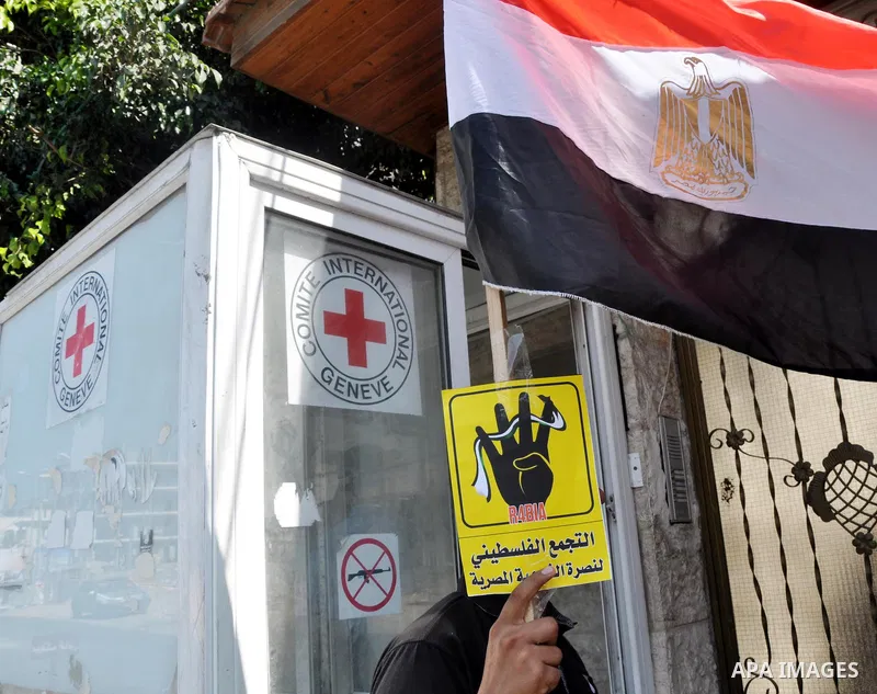 Palestinians protester carry a placard and gestures during a rally in support of ousted Egyptian president Mohamed Morsi, in Gaza City on August 20, 2013. Egypt closed its Rafah border crossing in Sinai with the Palestin...