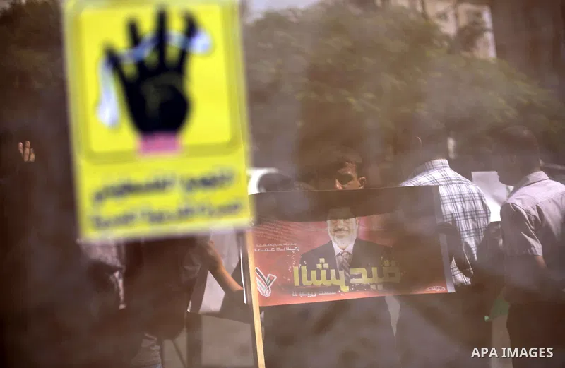 Palestinians protester carry a placard and gestures during a rally in support of ousted Egyptian president Mohamed Morsi, in Gaza City on August 20, 2013. Egypt closed its Rafah border crossing in Sinai with the Palestin...