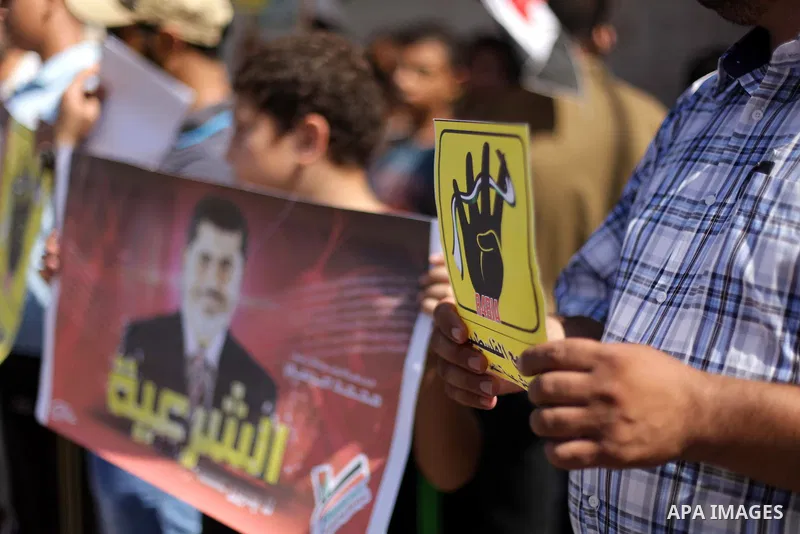 Palestinians protester carry a placard and gestures during a rally in support of ousted Egyptian president Mohamed Morsi, in Gaza City on August 20, 2013. Egypt closed its Rafah border crossing in Sinai with the Palestin...