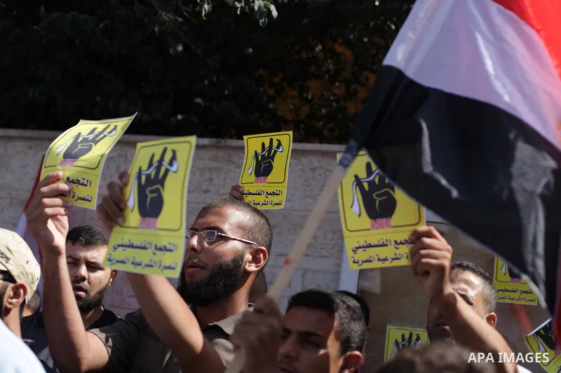 Palestinians protester carry a placard and gestures during a rally in support of ousted Egyptian president Mohamed Morsi, in Gaza City on August 20, 2013. Egypt closed its Rafah border crossing in Sinai with the Palestin...