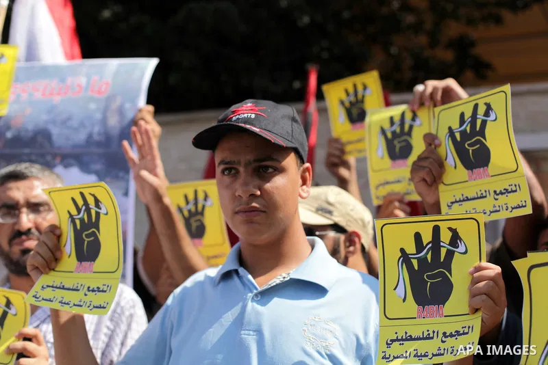Palestinians protester carry a placard and gestures during a rally in support of ousted Egyptian president Mohamed Morsi, in Gaza City on August 20, 2013. Egypt closed its Rafah border crossing in Sinai with the Palestin...