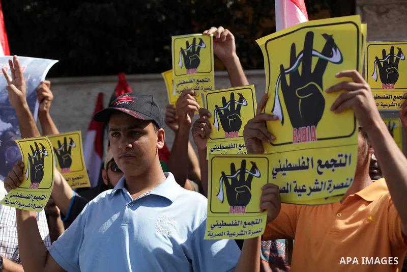 Palestinians protester carry a placard and gestures during a rally in support of ousted Egyptian president Mohamed Morsi, in Gaza City on August 20, 2013. Egypt closed its Rafah border crossing in Sinai with the Palestin...