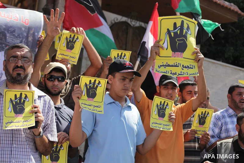 Palestinians protester carry a placard and gestures during a rally in support of ousted Egyptian president Mohamed Morsi, in Gaza City on August 20, 2013. Egypt closed its Rafah border crossing in Sinai with the Palestin...