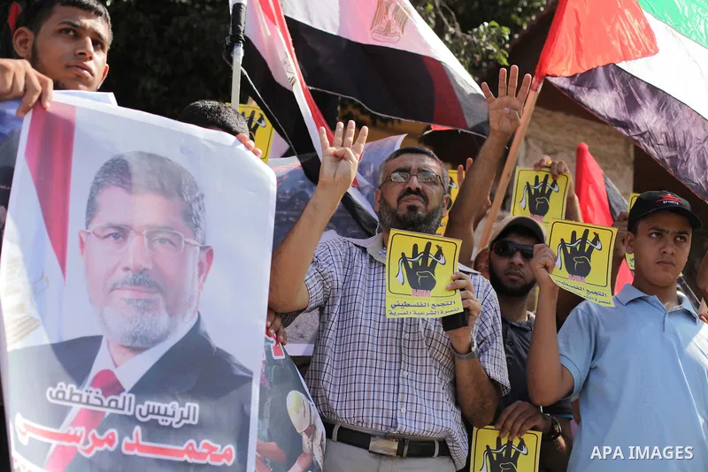 Palestinians protester carry a placard and gestures during a rally in support of ousted Egyptian president Mohamed Morsi, in Gaza City on August 20, 2013. Egypt closed its Rafah border crossing in Sinai with the Palestin...