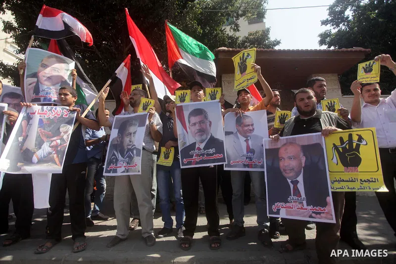 Palestinians protester carry a placard and gestures during a rally in support of ousted Egyptian president Mohamed Morsi, in Gaza City on August 20, 2013. Egypt closed its Rafah border crossing in Sinai with the Palestin...