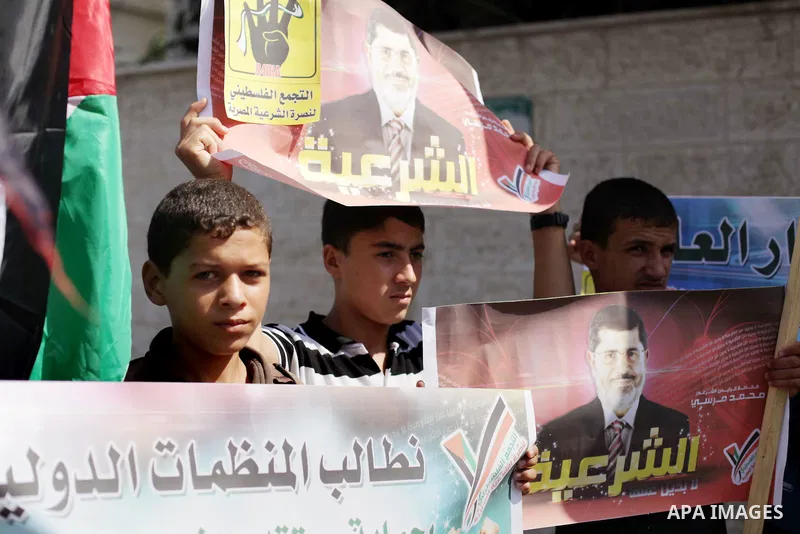 Palestinians protester carry a placard and gestures during a rally in support of ousted Egyptian president Mohamed Morsi, in Gaza City on August 20, 2013. Egypt closed its Rafah border crossing in Sinai with the Palestin...