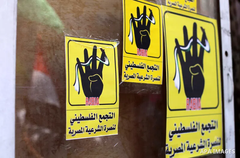 Palestinians protester carry a placard and gestures during a rally in support of ousted Egyptian president Mohamed Morsi, in Gaza City on August 20, 2013. Egypt closed its Rafah border crossing in Sinai with the Palestin...