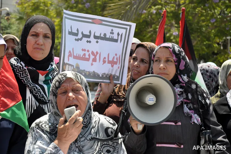 Palestinian women gather for a demonstration calling for the end of the political division between the Gaza Strip Hamas-led leadership and the Palestinian Authority Fatah-led in the West Bank city of Ramallah, on Aug. 20...