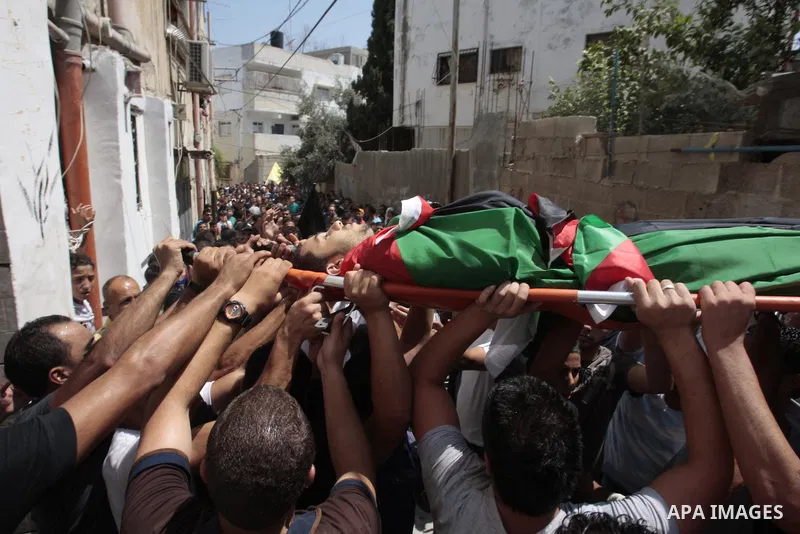 Palestinian mourners carry the body of Majd Lahlouh during his funeral at Jenin refugee camp in the West Bank city of Jenin on August 20, 2013. Israeli troops shot dead the Palestinian youth and wounded two others during...