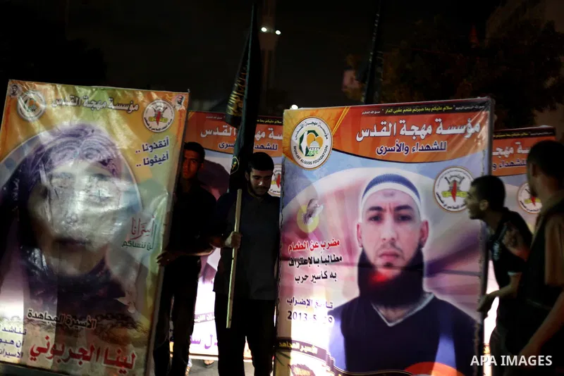 Palestinian supporters of Jihad Islamic movement take part in a march to commemorate the 43rd anniversary of the attempted burning of the Al-Aqsa mosque, in Gaza City on Aug 20, 2013. Photo by Ashraf Amra