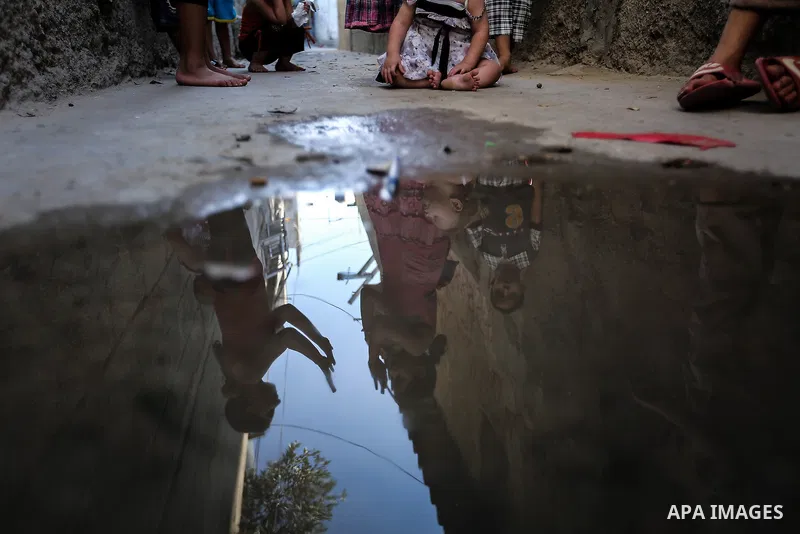 A picture taken on July 30, 2013 shows reflection of Palestinian children playing outside their homes in Jabalia refugee camp northern Gaza Strip. Photo by Mahmoud Hamda