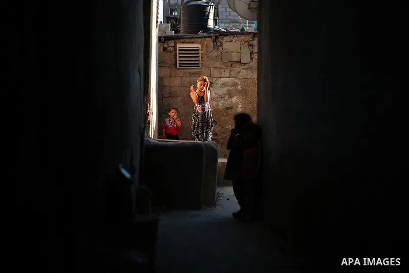 A picture taken on July 30, 2013 shows Palestinian children playing outside their homes in Jabalia refugee camp northern Gaza Strip. Photo by Mahmoud Hamda