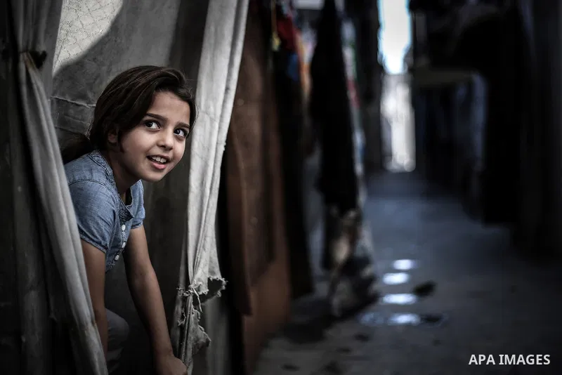 A picture taken on July 31, 2013 shows a Palestinian girl playing outside her family home in Jabalia refugee camp northern Gaza Strip. Photo by Mahmoud Hamda