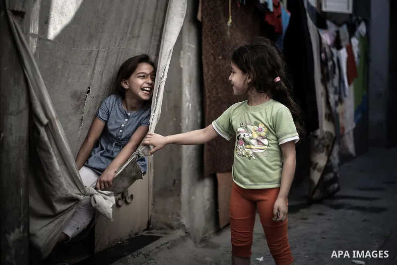 A picture taken on July 31, 2013 shows Palestinian girls playing outside their homes in Jabalia refugee camp northern Gaza Strip. Photo by Mahmoud Hamda