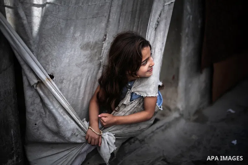 A picture taken on July 31, 2013 shows a Palestinian girl playing outside her family home in Jabalia refugee camp northern Gaza Strip. Photo by Mahmoud Hamda