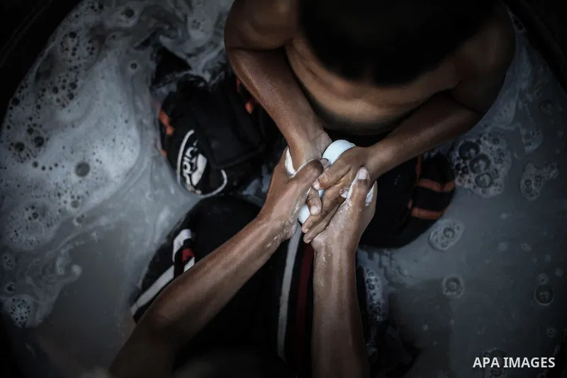 A picture taken on July 31, 2013 shows Palestinian children bathing in front of their home in Jabalia refugee camp northern Gaza Strip. Photo by Mahmoud Hamda