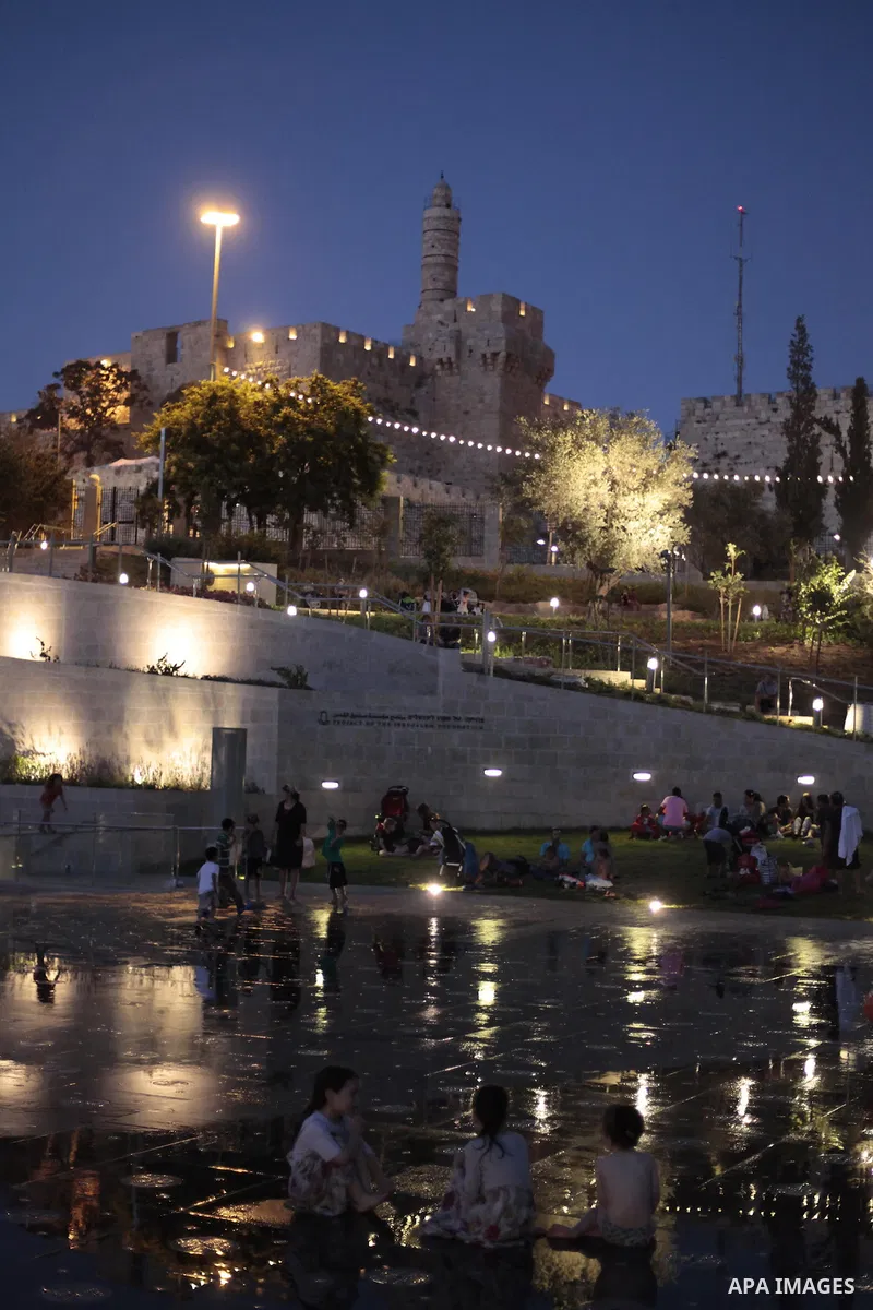 Palestinian children enjoy themselves with water in public parks founded by Israeli municipality near the wall of Jerusalem in the old town, on Aug. 20, 2013. Photo by Saeed Qaq