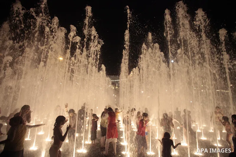 Palestinian children enjoy themselves with water in public parks founded by Israeli municipality near the wall of Jerusalem in the old town, on Aug. 20, 2013. Photo by Saeed Qaq