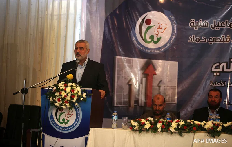 Palestinian Prime Minister in the Gaza Strip, Ismail Haniya, speaks during the opening of the national program for the performance indicators for charity associations and community organizations, in Gaza city, on Aug. 21...