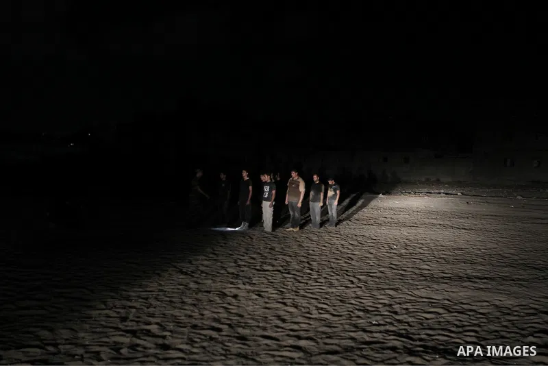 Palestinian youths take part in a night military-style exercises run by militants from the al-Nasser Brigades, an armed wing of the Popular Resistance Committees (PRC), at their training camp in Gaza City, Tuesday, Aug....