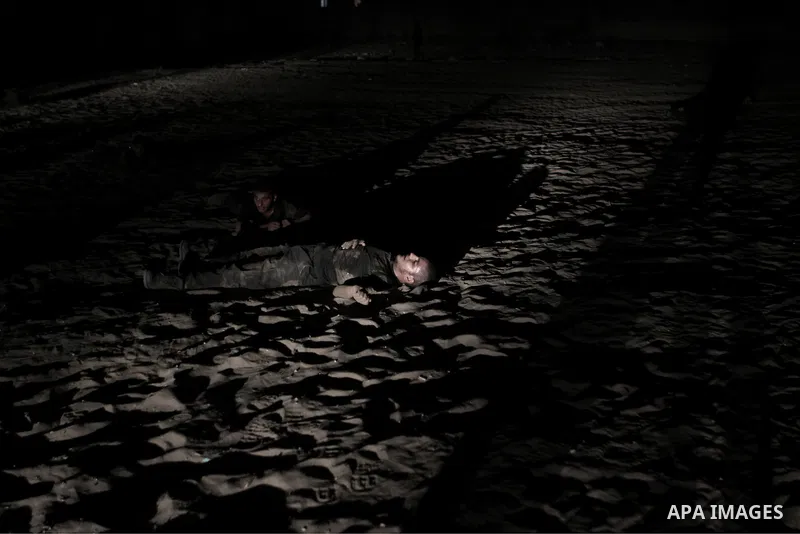 Palestinian youths crawl during a night military-style exercises run by militants from the al-Nasser Brigades, an armed wing of the Popular Resistance Committees (PRC), at their training camp in Gaza City, Tuesday, Aug....