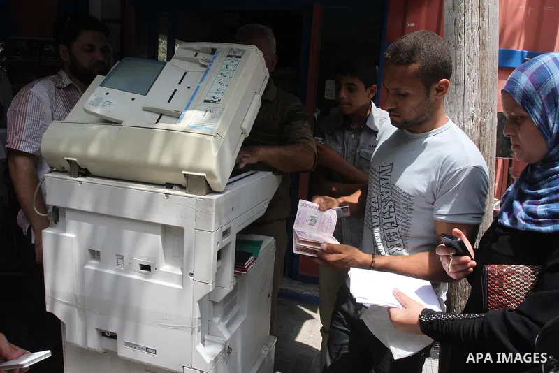 Palestinians photocopy their papers and passports to register for travel throw the Beit Hanoun crossing (Erez) in front of the Ministry of Civil affairs' office, in Gaza City Aug 21, 2013. Israel and the Palestinians hav...